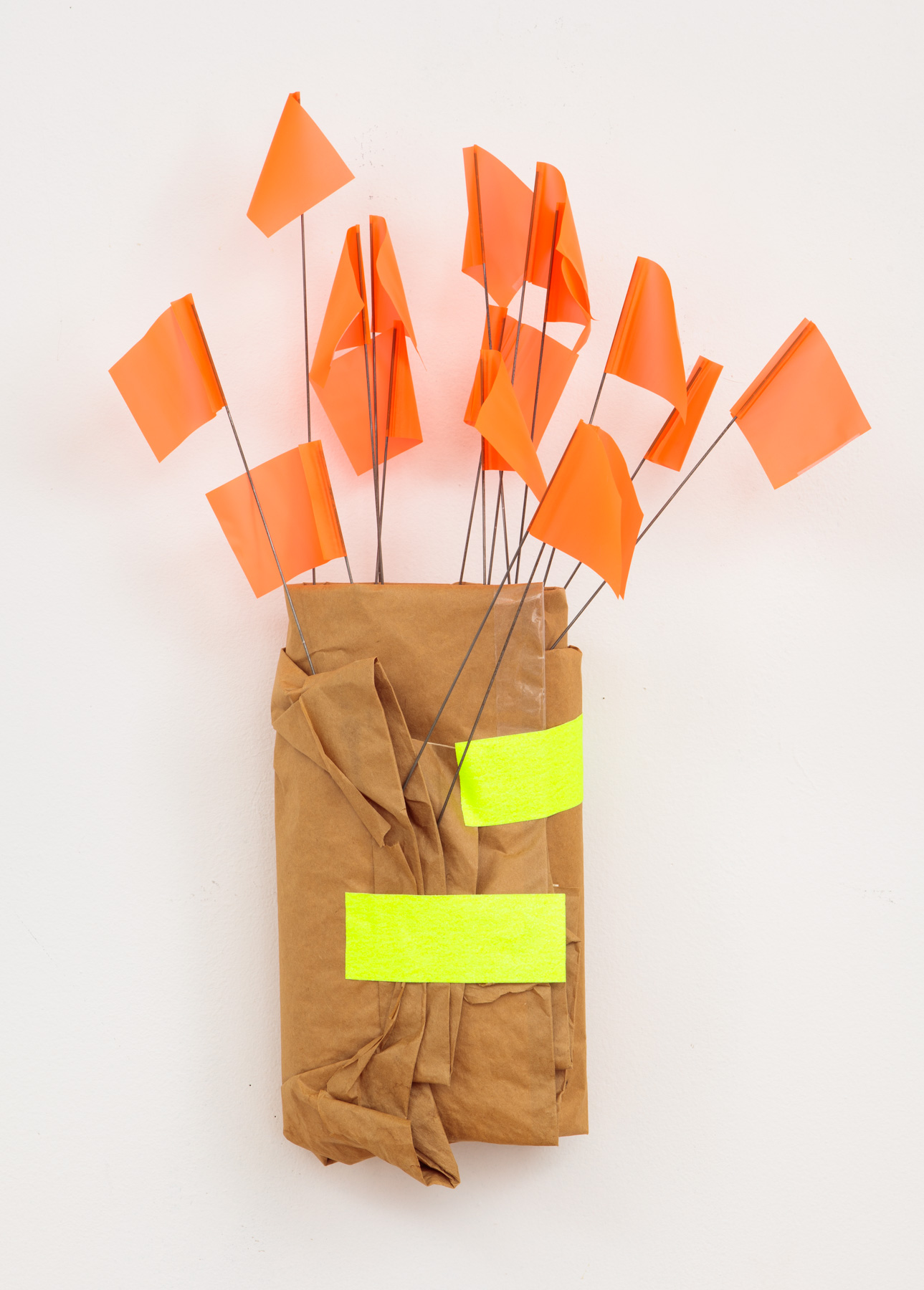 roll of brown paper with flourscent orange flags
