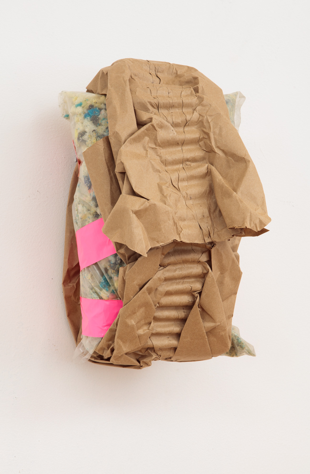 brown paper wrapped around a plastic bag of stuffing foam