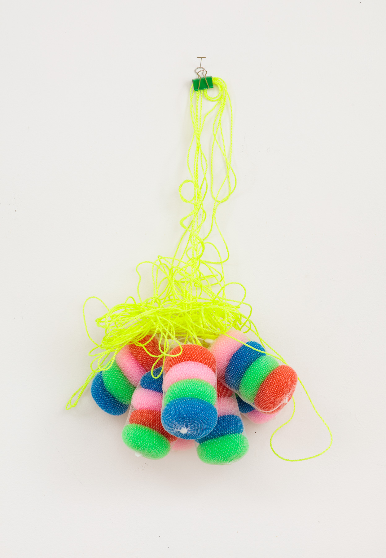 round scrubbies hanging from yellow flourescent rope